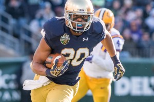 Dec 30, 2014; Nashville, TN, USA; Notre Dame Fighting Irish wide receiver C.J. Prosise (20) carries the ball in the first quarter against the Louisiana State Tigers at LP Field. Notre Dame won 31-28. Mandatory Credit: Matt Cashore-USA TODAY Sports