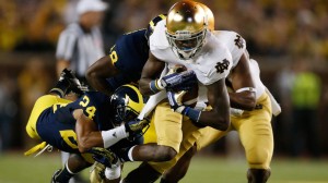 The Michigan Wolverines defeated the Notre Dame Fighting Irish Saturday night, 41-30 — and then celebrated by playing some polka. Here, the Irish's Chris Brown is tackled by Michigan's Delonte Hollowell after making a catch. (Photo:vGregory Shamus/Getty Images)