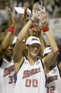 Ruth Riley raises MVP trophy in 2003 with the Detroit Shock. [Photo from RuthRiley.com]