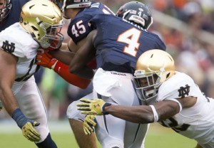 Notre Dame's Elijah Shumate (22) tackles Virginia's Taquan Mizzell (4) during the second half of the Fighting Irish's 34-27 win over Virginia Saturday, September 12, 2015 in Charlottesville. (SBT Photo/BECKY MALEWITZ)