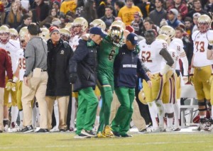 Senior cornerback KeiVarae Russell is helped off the field during Notre Dame’s 19-16 victory over Boston College on Saturday. Russell was diagnosed with a broken tibia and is out for six to eight weeks. (Photo by Caroline Genco / The Observer)