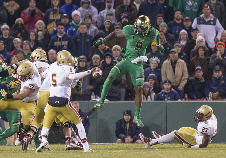 Notre Dame’s Jaylon Smith (9) leaps over Boston College’s Myles Willis (23) as QB Jeff Smith (5) passes during the second half of the Notre Dame-Boston College NCAA football game on Saturday, Nov. 21, 2015, inside Fenway Park in Boston, Mass. SBT Photo/ROBERT FRANKLIN