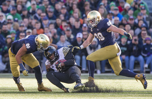 Notre Dame’s James Onwualu (17) and Joe Schmidt (38) defend Wake Forest’s Kendall Hinton (2) during the Notre Dame-Wake Forest NCAA college football game on Saturday, Nov. 14, 2015, at Notre Dame Stadium in South Bend. SBT Photo/ROBERT FRANKLIN