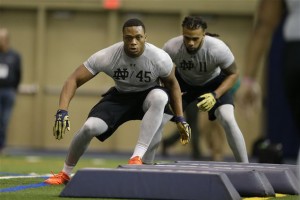 Notre Dame's Romeo Okwara (45) and Ishaq Williams run a drill during Notre Dame's NFL football Pro Day in South Bend, Ind., Thursday, March 31, 2016. (AP Photo/Michael Conroy)