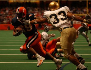 SU's Walter Reyes scores his fifth touchdown of the day against Notre Dame as he runs past Courtney Watson in the fourth quarter on December 6, 2003. Syracuse won 38-12. (Syracuse.com/Post-Standard 2003)