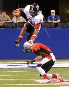 Jaylon Smith leaps over Cardinal Ritter's Jalen Chandler during the fourth quarter of play in the Class 2A IHSAA football championship game Friday night at Lucas Oil Stadium in Indianapolis.