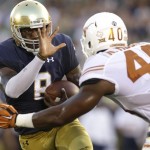 Notre Dame quarterback Malik Zaire, left, runs with the ball against Texas defensive end Naashon Hughes during the first half of an NCAA college football game Sept. 5, 2015, in South Bend, Ind. (AP Photo/Nam Y. Huh)