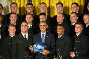 President Barack Obama holds a Navy football helmet & ring while pausing for a photo with the Naval Academy football team after the president awarded the Commander in Chief's Trophy to the team at the White House in Washington, D.C. April 27, 2016. (DoD News photo by EJ Hersom)