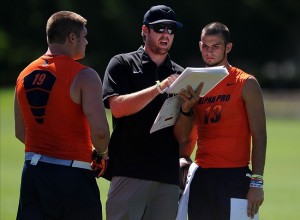 Tight end Henry Mondeaux (19) and quarterback Will Grier (13) listen as coach Jordan Palmer during the Nike 7on7 elimination play at Nike World Headquarters. Credit: Steve Dykes / USA TODAY Sports