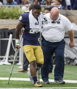 Notre Dame's Shaun Crawford (20) leaves the field with an injury during the Notre Dame - Nevada game. (Robert Franklin, South Bend Tribune.)