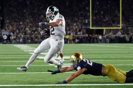 R.J. Shelton #12 of the Michigan State Spartans scores a touchdown in front of Drue Tranquill #23 of the Notre Dame Fighting Irish during the first half of a game at Notre Dame Stadium on September 17, 2016 in South Bend, Indiana. Credit: Stacy Revere/Getty Images